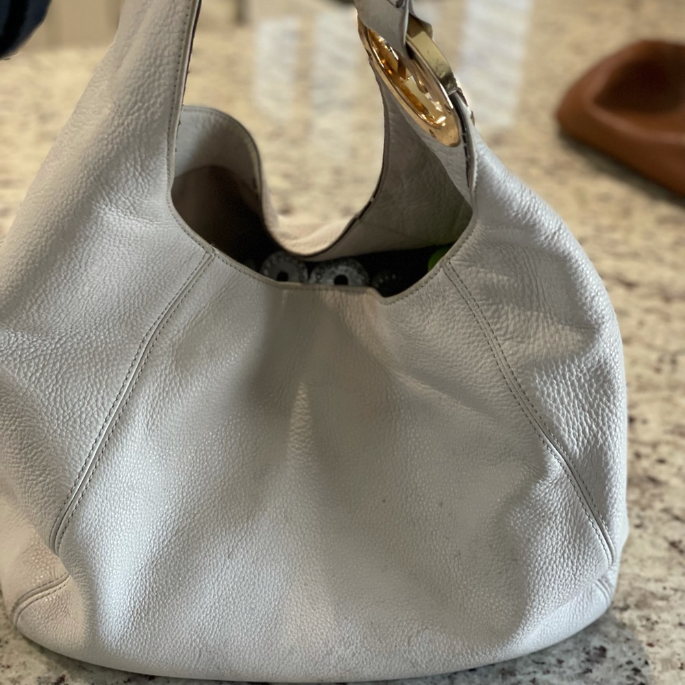 Michael Kors soft leather, white, large hobo style purse gold detail.